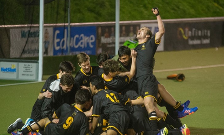 A college team celebrate points won during a rugby game