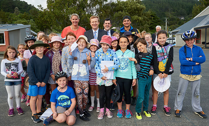 Minister poses with teacher and students