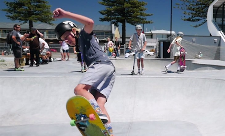 A boy on his skateboard at a skatepark