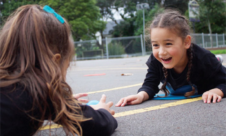 two tamariki playing on a court