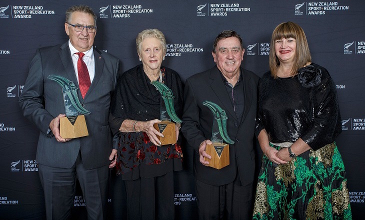 Three award winners standing with Raelene Castle