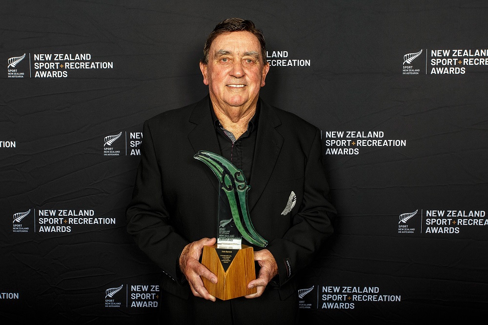 Dick Garrett holding his award