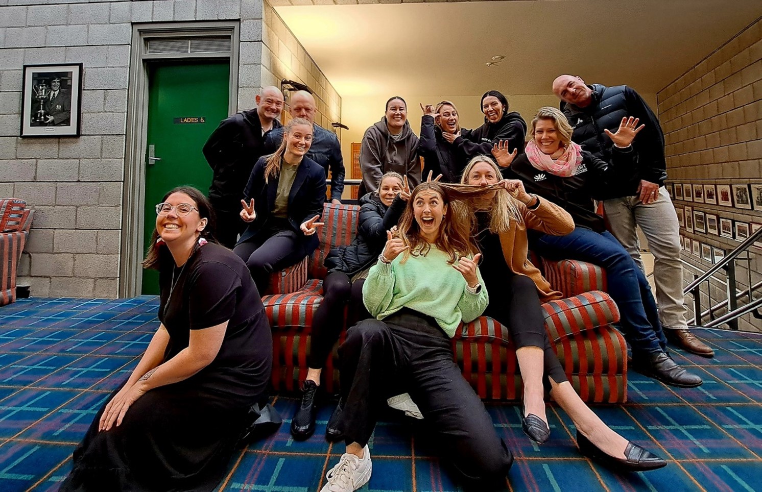 Group of people sitting on or around a couch