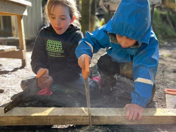 kids sawing through wood