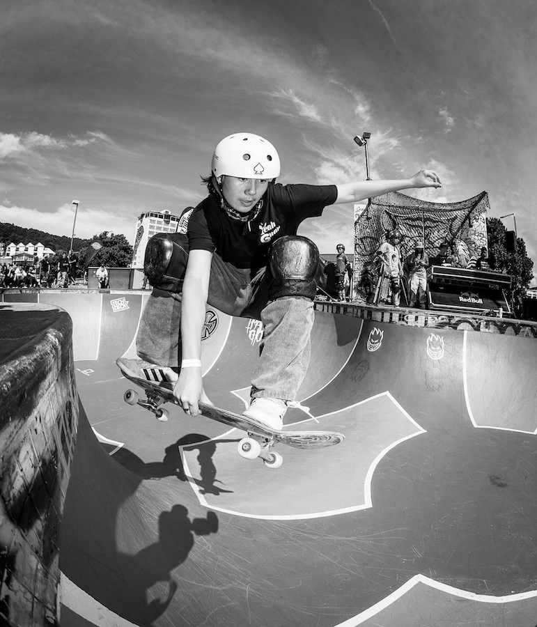 Girl doing skateboard tricks on a ramp