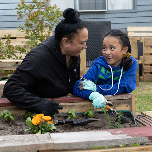 A mother and daughter enjoying planting flowers together