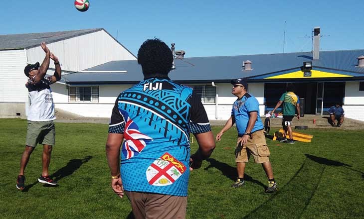 three Southland Fijian's throwing a ball