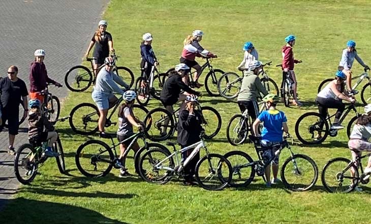 Group of people in lines getting ready to ride their bikes