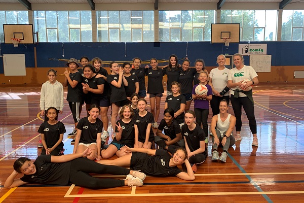 Group of young women at an indoor basketball court