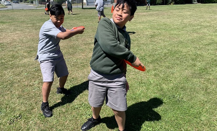 Two kids preparing to throw a frisbee