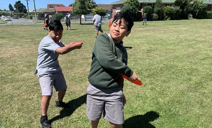 Two kids preparing to throw a frisbee