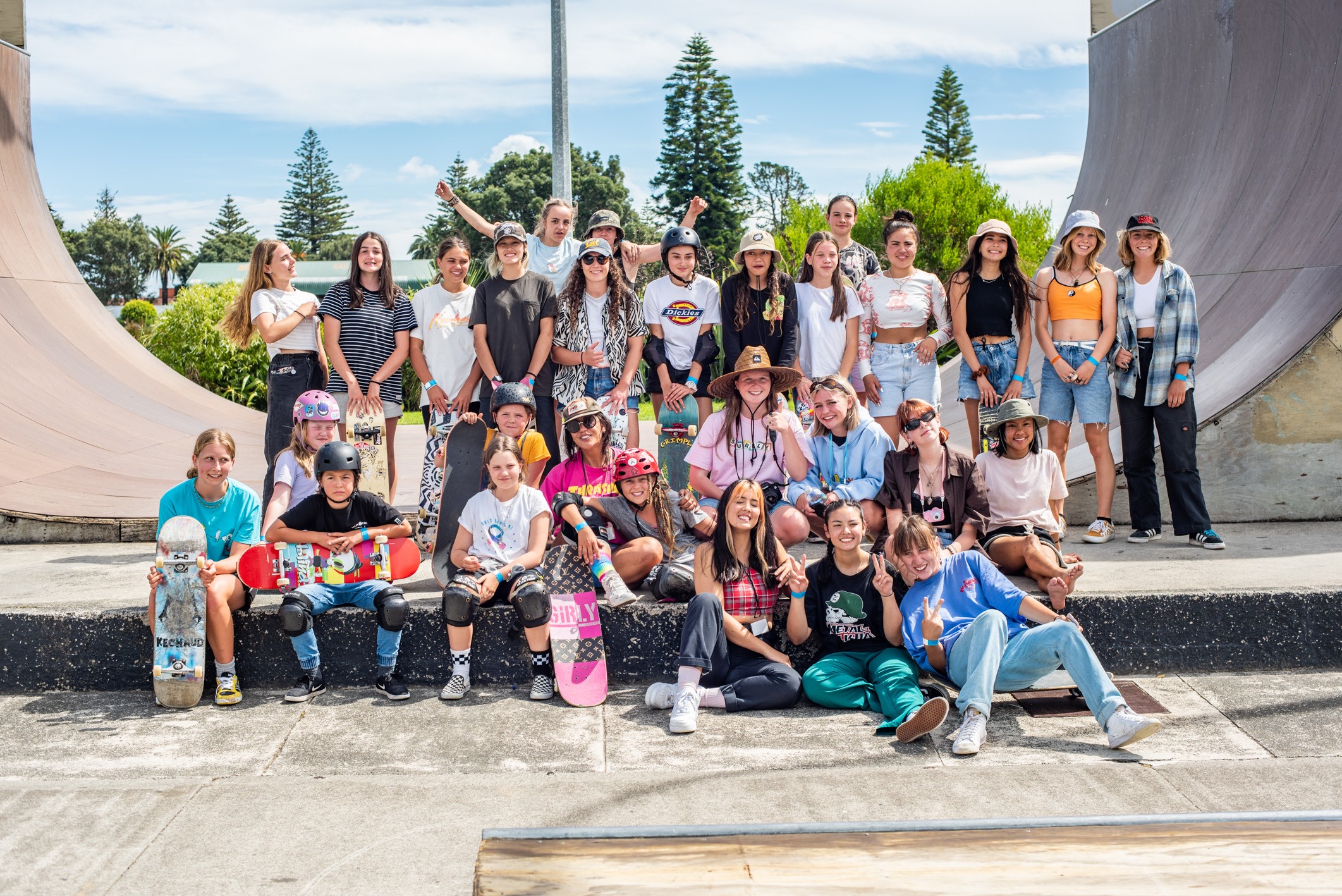 Group of young women sitting on a skateboarding ramp