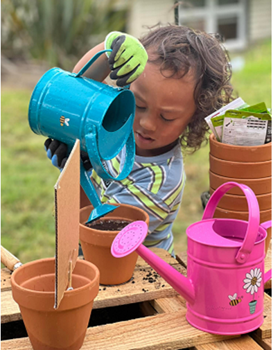 Child playing with watering cans