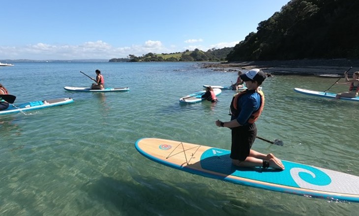 Group of women trying paddleboarding