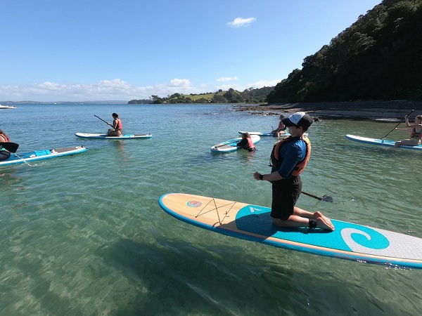 Group of women trying paddleboarding
