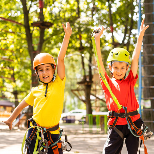 Tamariki wearing climbing gear