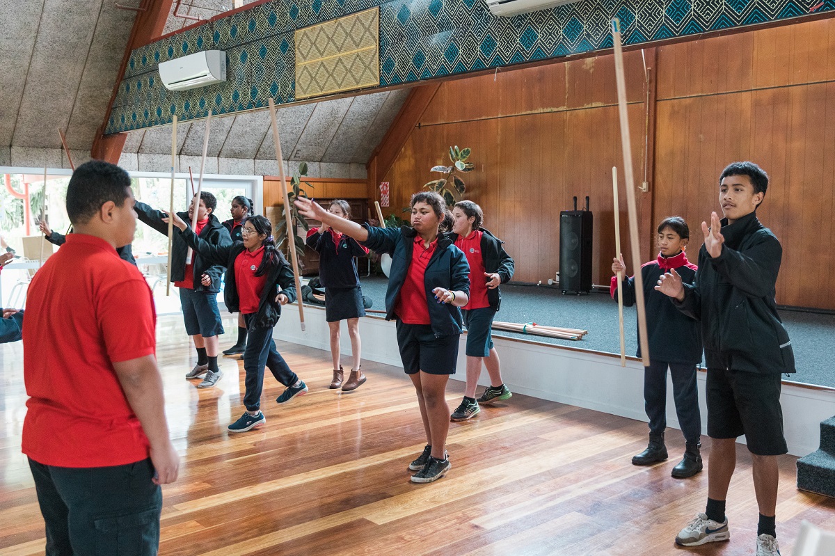 Young people playing traditional games in a marae