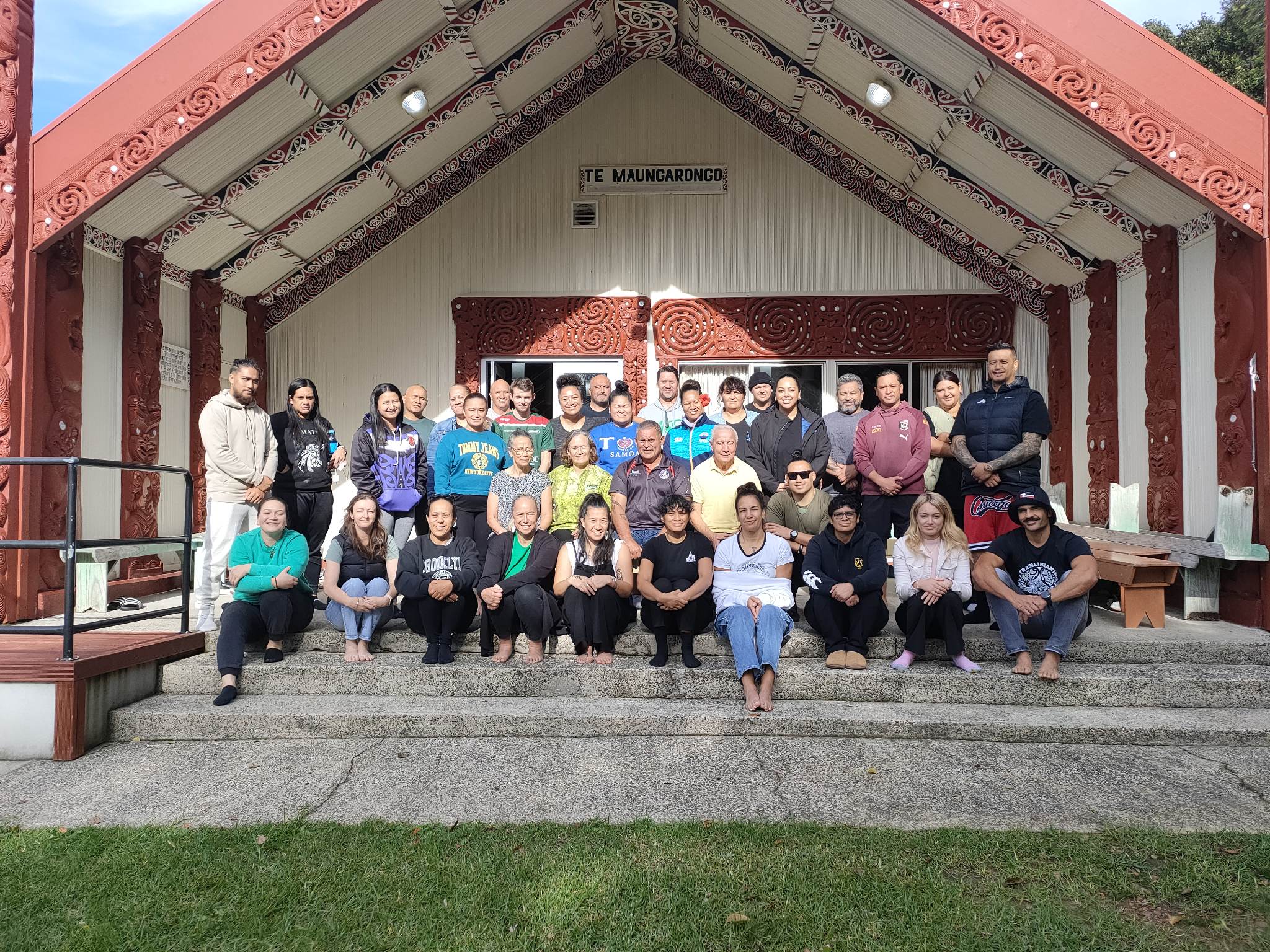 Group of people standing in front of Ohope Marae