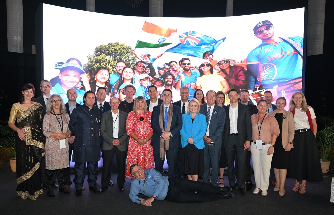 Group standing in front of a banner