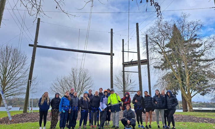 Group of young women in front of a high ropes course