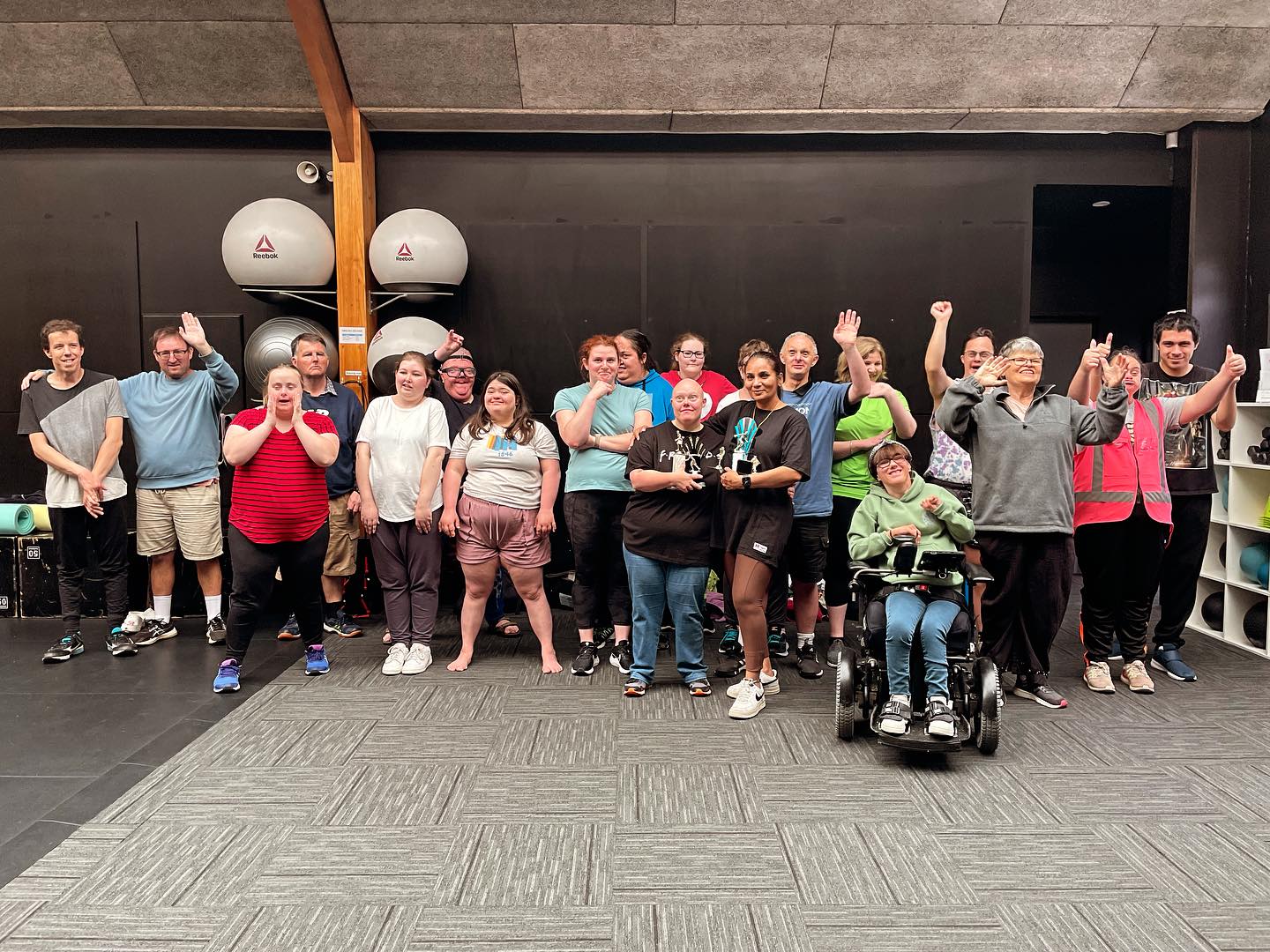 Group of people looking to camera in a gym setting