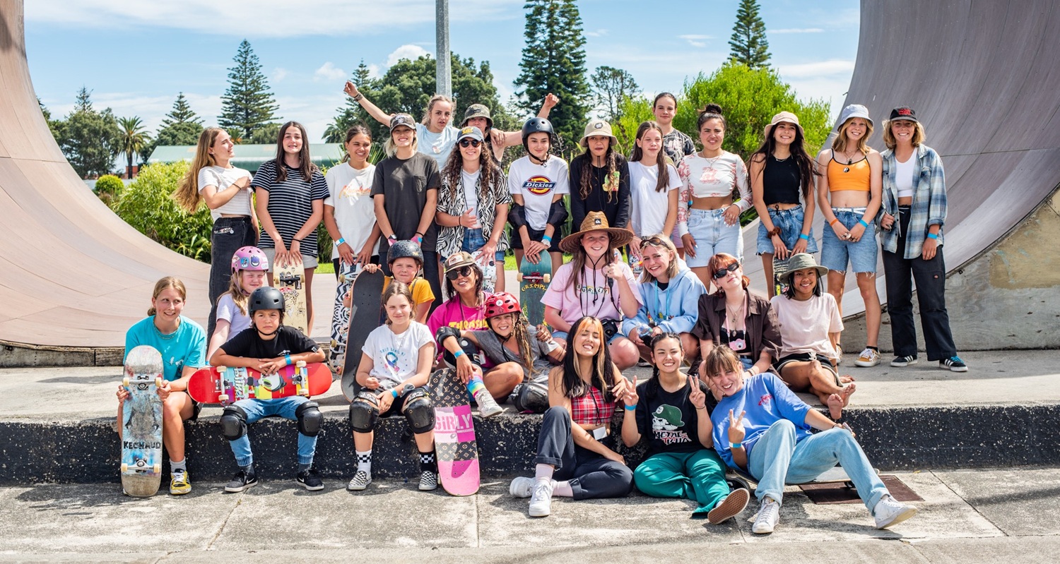 Group of young women sitting on a skateboarding ramp