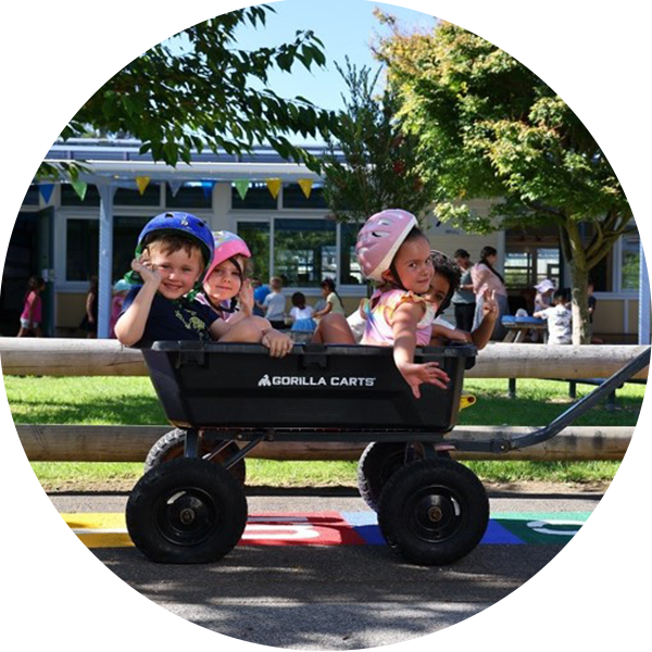 Four tamariki being pulled in a cart