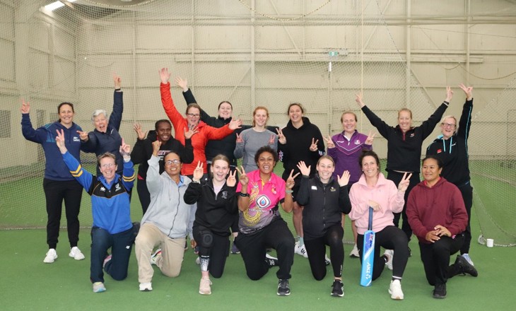 Group of women with their hands raised in celebration