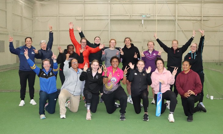 Group of women with their hands raised in celebration