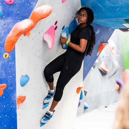 Rangatahi climbing a wall
