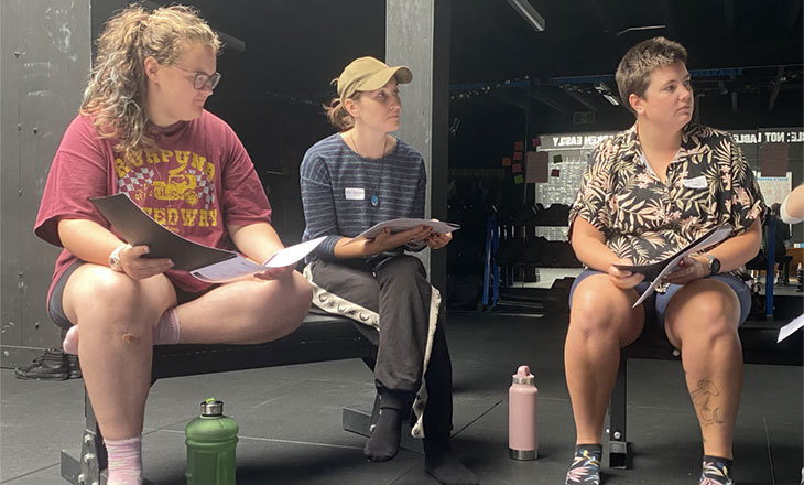 3 people sitting in chairs looking to the right