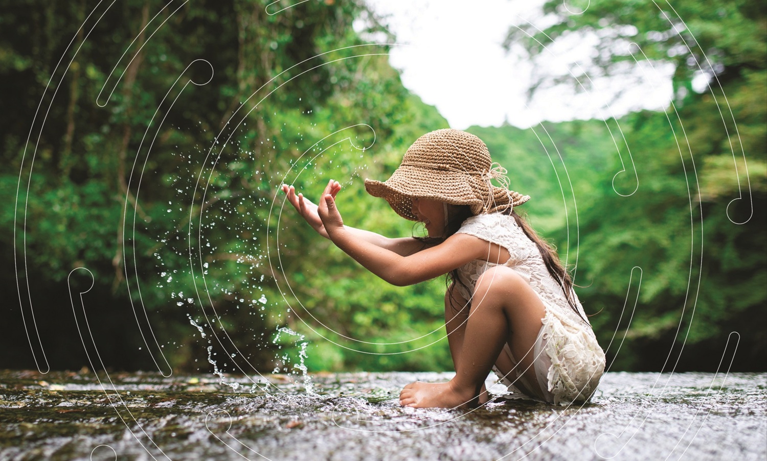 Young girl playing with water in a creek