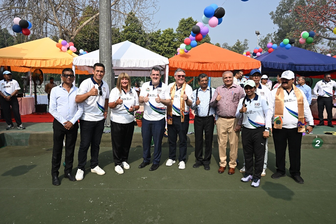 Group in cricket whites giving the thumbs up