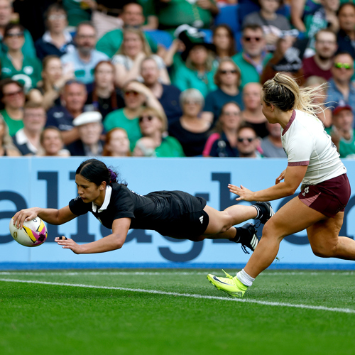 Womens rugby player scoring a try