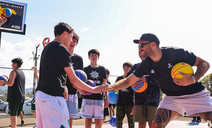 Basketball team and coach on the court