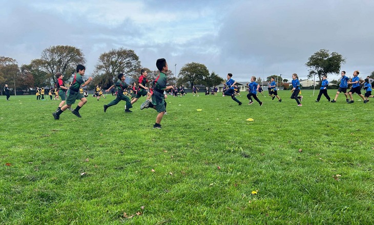 Tamariki running on a field