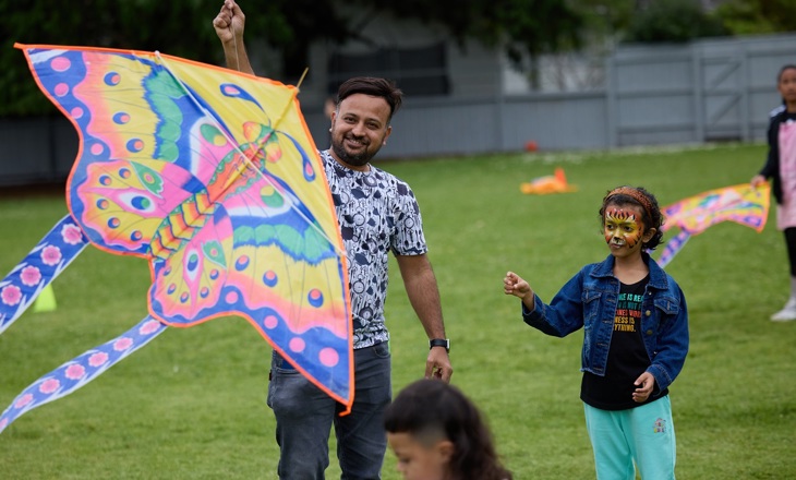 Kids playing with a butterfly shaped kite