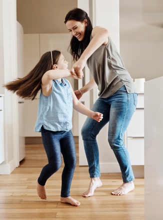 Mother and daughter playing inside