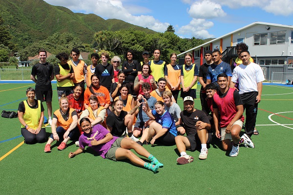 Group of young people looking to camera on an outdoor basketball court