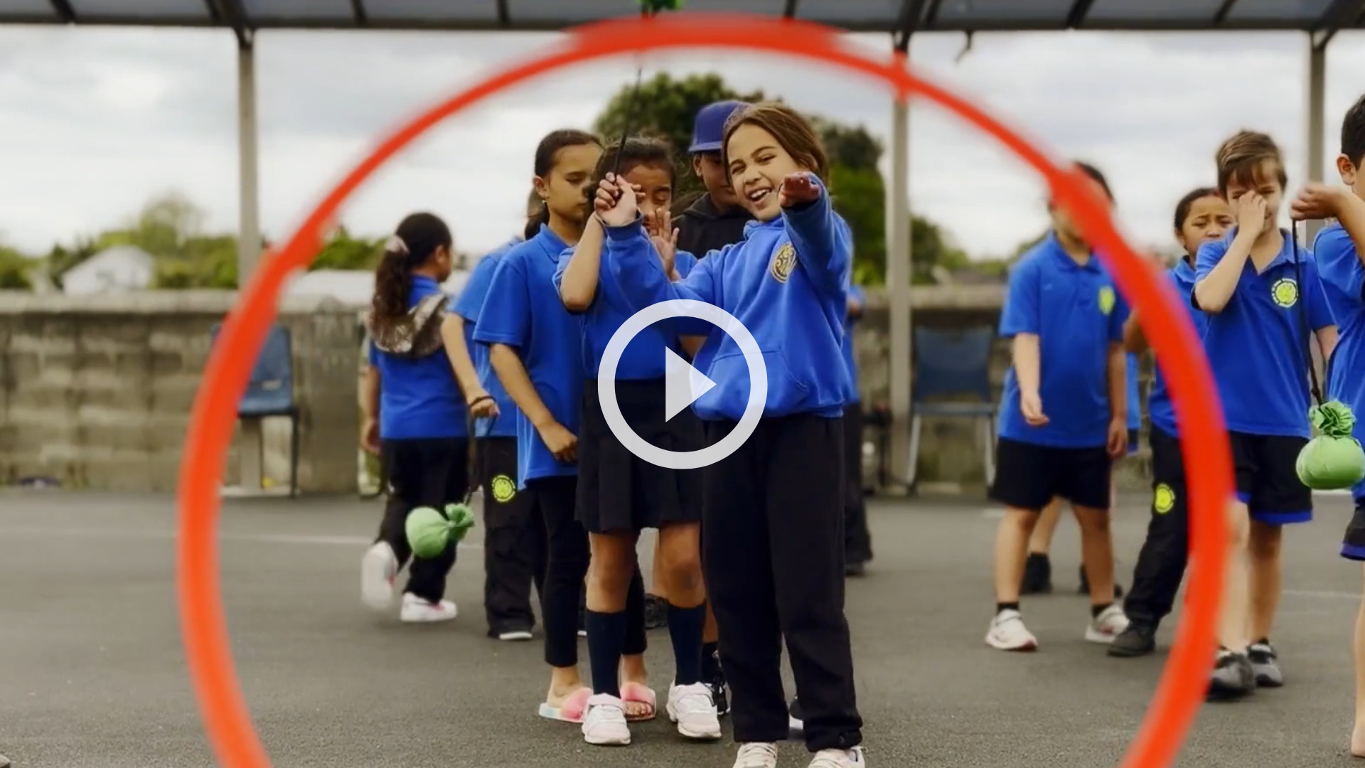 Girl aiming for a target looking to camera