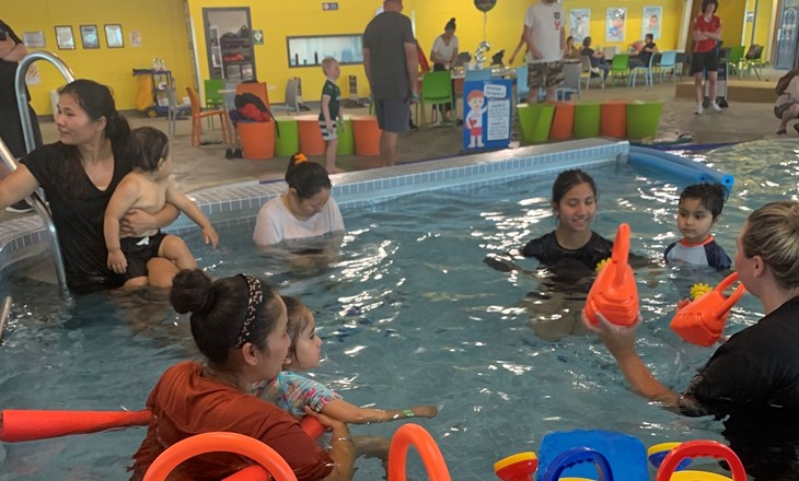 Group of families playing in a pool