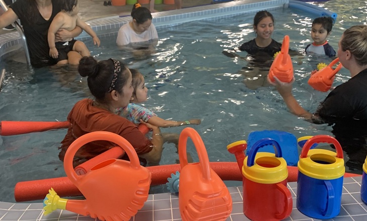 Group of families playing in a pool