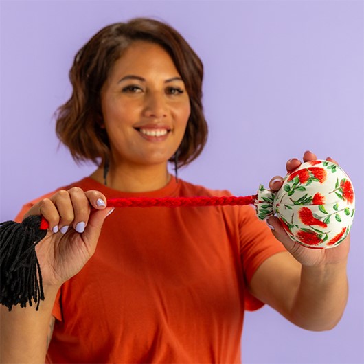 Woman in a red shirt holding a poi