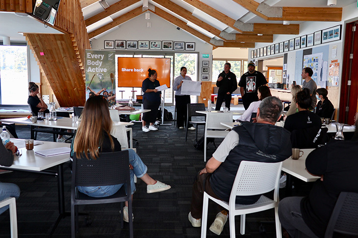 Adults sitting in a group setting in a classroom