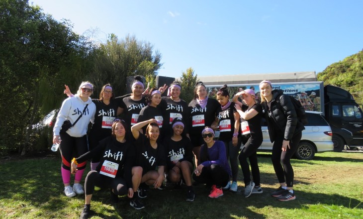 Young women standing as a group wearing SHIFT tshirts