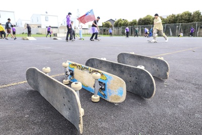Skatboards lying on their side on a school court