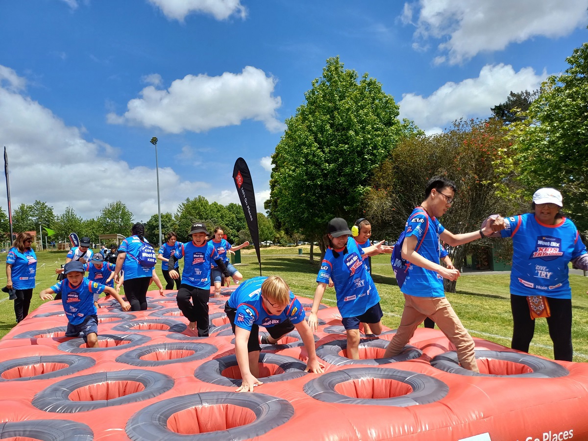 Tamariki playing on an obstacle course