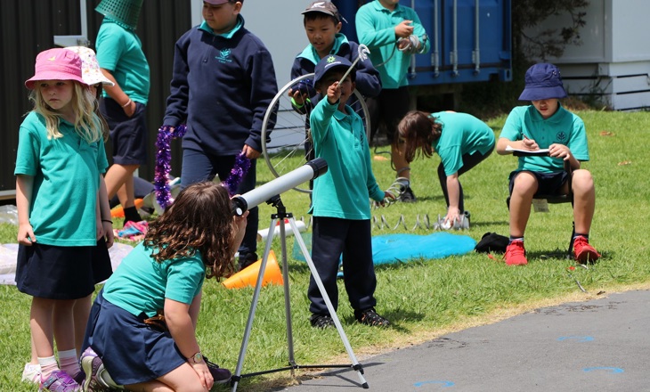 School kids playing on grass