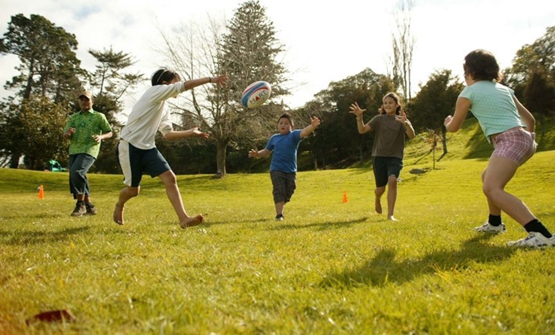 Group throwing a ball in a park