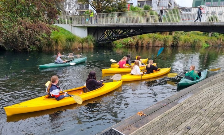 GirlGuides canoeing down a river